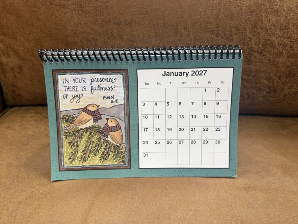 2027 Sunshine Sue desk calendar on its spiral easel, open to January